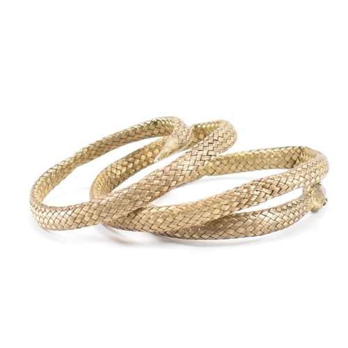 220 - A 19th Century Victorian Russian silver gilt snake bangle. The bangle made from woven gilt silver wi... 