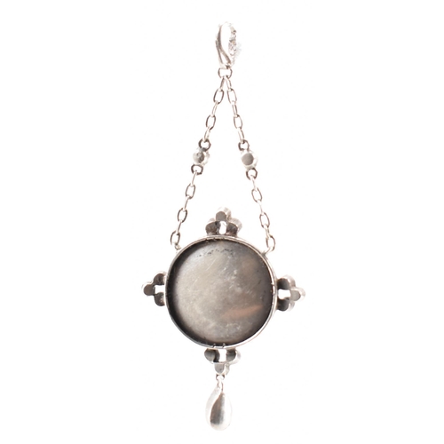 221 - A 19th Century Victorian silver and mother of pearl pendant having a round disc to the centre with w... 