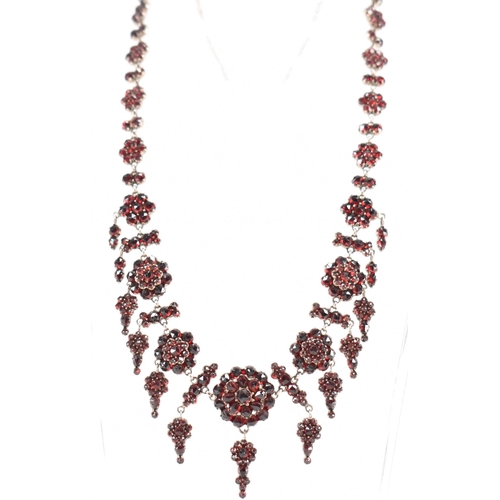 222 - A 19th Century Victorian garnet collar necklace. Th necklace constructed from clusters of round face... 