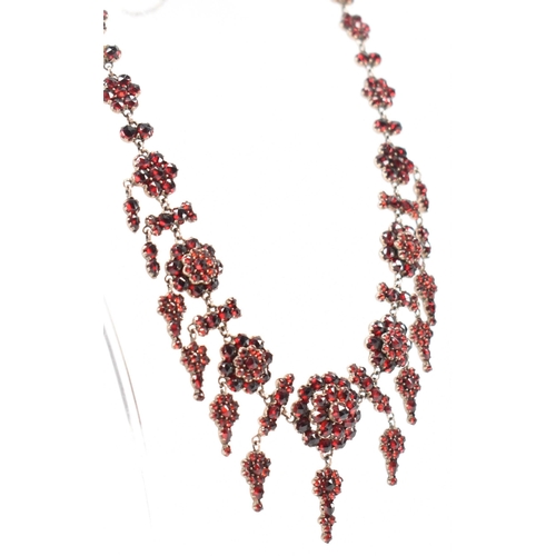 222 - A 19th Century Victorian garnet collar necklace. Th necklace constructed from clusters of round face... 