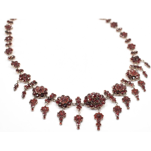 222 - A 19th Century Victorian garnet collar necklace. Th necklace constructed from clusters of round face... 