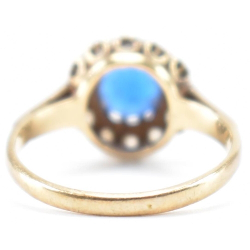 223 - A hallmarked 9ct gold blue and white stone ring. The ring being set with a round cut blue stone with... 