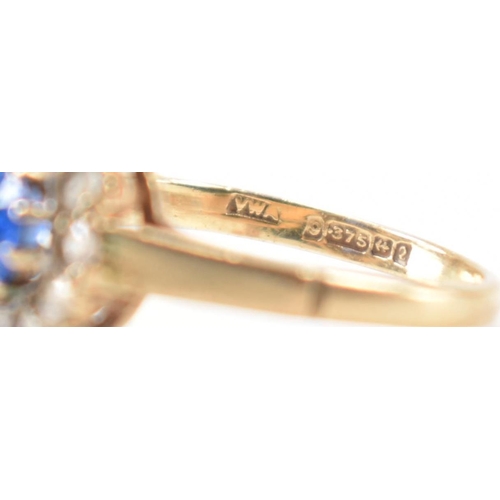 223 - A hallmarked 9ct gold blue and white stone ring. The ring being set with a round cut blue stone with... 