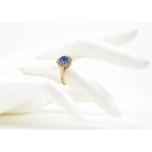 223 - A hallmarked 9ct gold blue and white stone ring. The ring being set with a round cut blue stone with... 