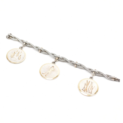 224 - A vintage Hermès silver skiing medallion bracelet. The bracelet constructed from three woven chains ... 