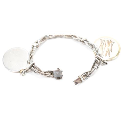 224 - A vintage Hermès silver skiing medallion bracelet. The bracelet constructed from three woven chains ... 