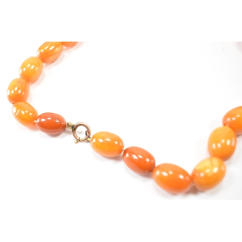 225 - A vintage butterscotch amber beaded necklace. The necklace having twenty seven oval beads. Largest c... 