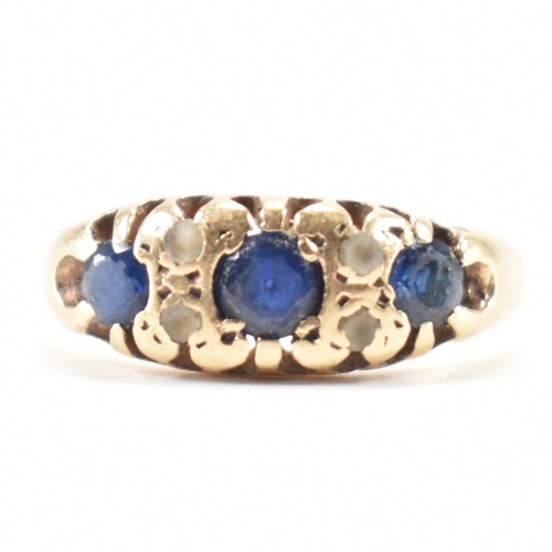 228 - A vintage gold blue and white stone ring. The ring being set with three round cut blue stones and wh... 