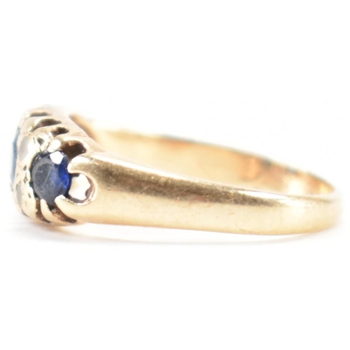 228 - A vintage gold blue and white stone ring. The ring being set with three round cut blue stones and wh... 