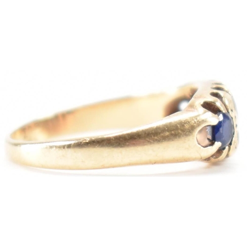 228 - A vintage gold blue and white stone ring. The ring being set with three round cut blue stones and wh... 