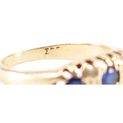 228 - A vintage gold blue and white stone ring. The ring being set with three round cut blue stones and wh... 