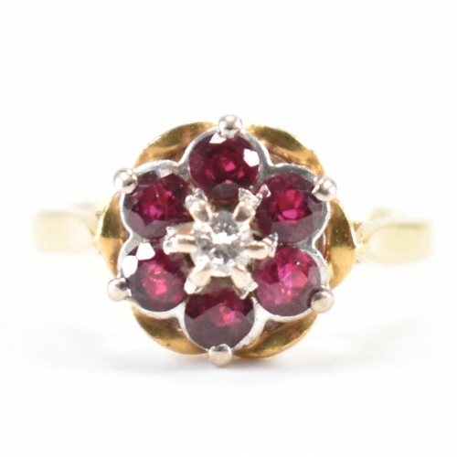 231 - A vintage 18ct yellow gold, ruby & diamond floral cluster ring. The ring having a central round bril... 