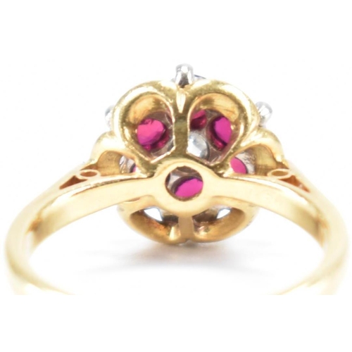 231 - A vintage 18ct yellow gold, ruby & diamond floral cluster ring. The ring having a central round bril... 