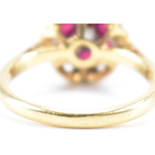 231 - A vintage 18ct yellow gold, ruby & diamond floral cluster ring. The ring having a central round bril... 