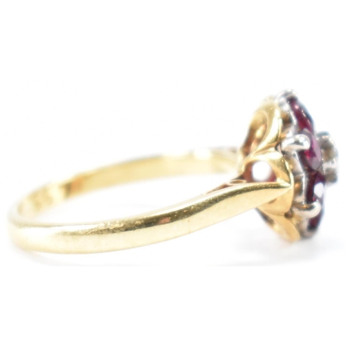 231 - A vintage 18ct yellow gold, ruby & diamond floral cluster ring. The ring having a central round bril... 