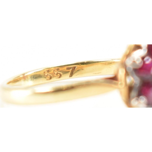 231 - A vintage 18ct yellow gold, ruby & diamond floral cluster ring. The ring having a central round bril... 