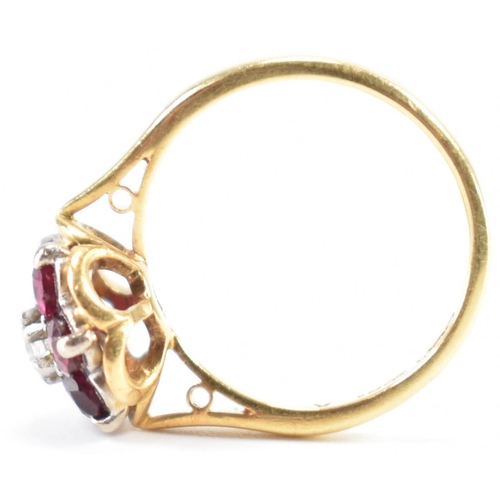 231 - A vintage 18ct yellow gold, ruby & diamond floral cluster ring. The ring having a central round bril... 