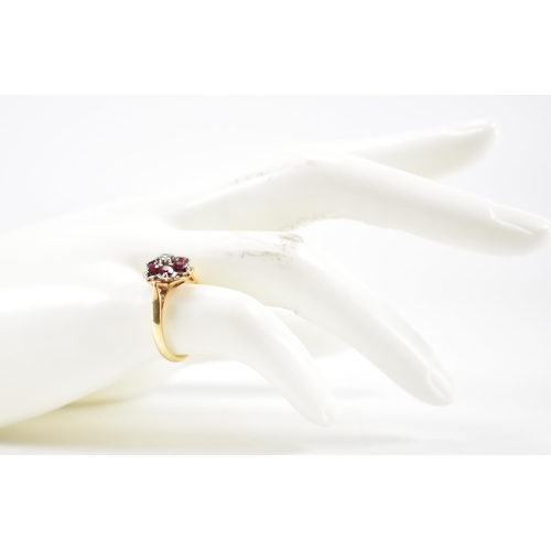 231 - A vintage 18ct yellow gold, ruby & diamond floral cluster ring. The ring having a central round bril... 