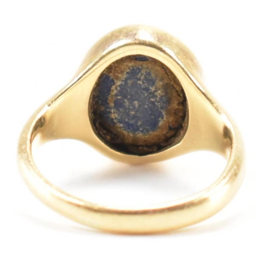 233 - A hallmarked 18ct gold signet ring having oval lapis lazuli panel to centre set within a bezel mount... 