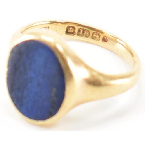 233 - A hallmarked 18ct gold signet ring having oval lapis lazuli panel to centre set within a bezel mount... 