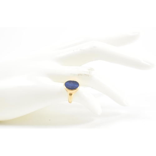 233 - A hallmarked 18ct gold signet ring having oval lapis lazuli panel to centre set within a bezel mount... 