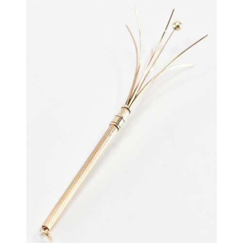 237 - A vintage 1960s hallmarked 9ct gold cocktail swizzle stick. The stick having engine turned detailing... 