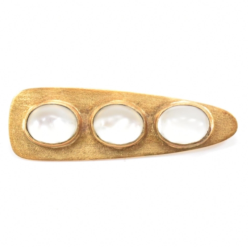 240 - A gold and moonstone pendant brooch. The brooch of brushed triangular form set with three oval moons... 