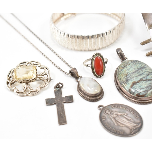 243 - A collection of silver jewellery. The lot to include a moonstone pendant necklace (marked 925), text... 