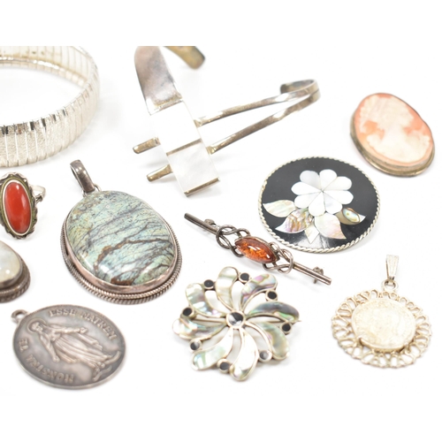 243 - A collection of silver jewellery. The lot to include a moonstone pendant necklace (marked 925), text... 