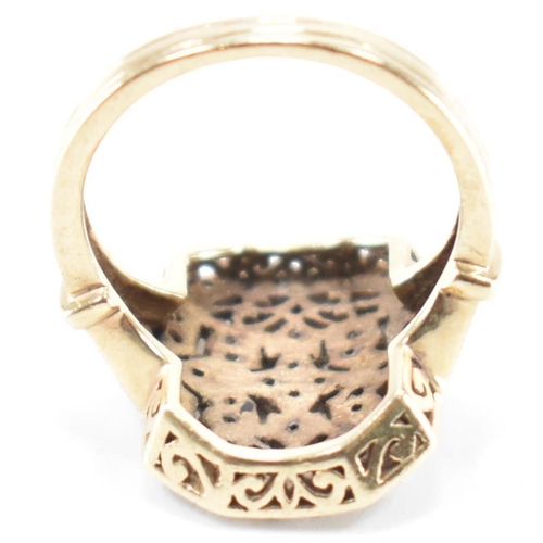 248 - A vintage gold and diamond panel ring. The ring having a canted rectangular panel to the head set th... 