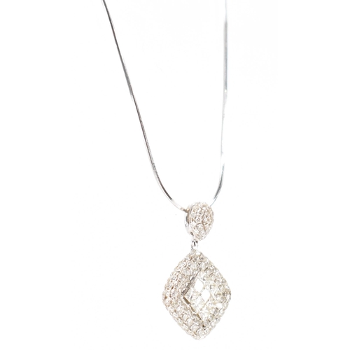 250A - A hallmarked 18ct white gold and diamond pendant necklace. The necklace having a fine snake chain wi... 