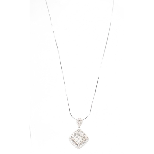 250A - A hallmarked 18ct white gold and diamond pendant necklace. The necklace having a fine snake chain wi... 