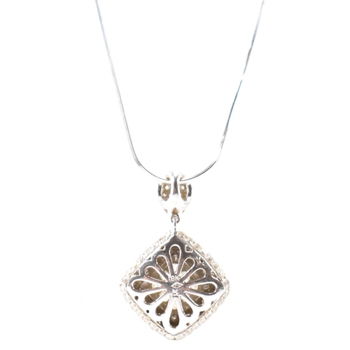 250A - A hallmarked 18ct white gold and diamond pendant necklace. The necklace having a fine snake chain wi... 