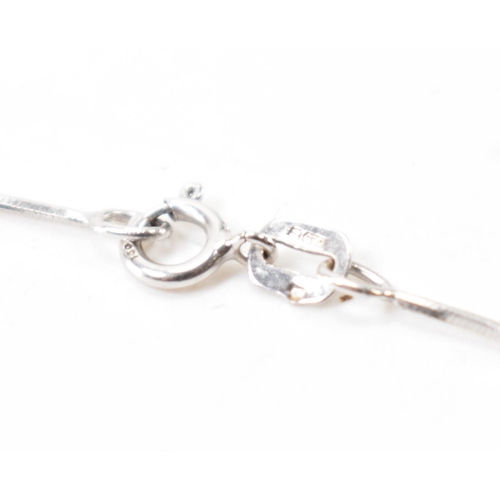 250A - A hallmarked 18ct white gold and diamond pendant necklace. The necklace having a fine snake chain wi... 