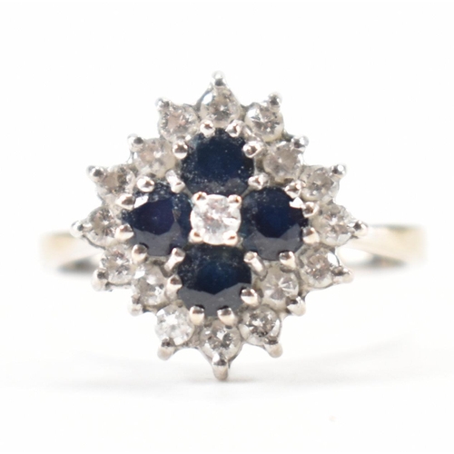 250 - A hallmarked 18ct white gold diamond and sapphire cluster ring. The ring being set with four round c... 