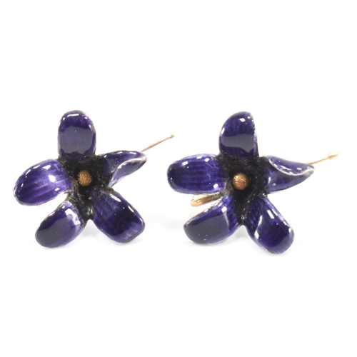 253 - A pair of vintage 18ct gold and enamel floral earrings. The flowers having purple enamel with gold h... 