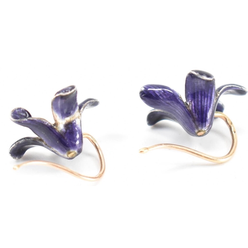 253 - A pair of vintage 18ct gold and enamel floral earrings. The flowers having purple enamel with gold h... 