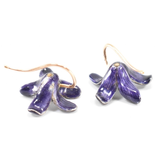 253 - A pair of vintage 18ct gold and enamel floral earrings. The flowers having purple enamel with gold h... 