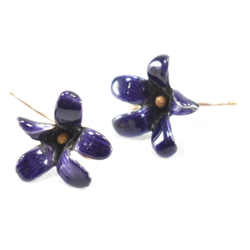 253 - A pair of vintage 18ct gold and enamel floral earrings. The flowers having purple enamel with gold h... 