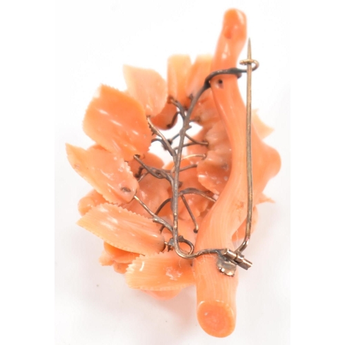 256 - A 19th Century Victorian carved coral brooch. The brooch constructed from a cluster of carved flower... 