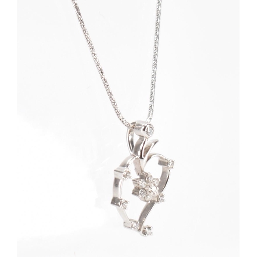 260a - A 18ct white gold and diamond pendant necklace. The necklace having a fine snake chain necklace with... 