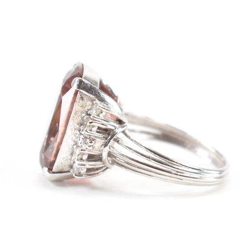 290 - A white gold tourmaline and diamond cocktail ring. The ring set with a pinkish brown tourmaline flan... 