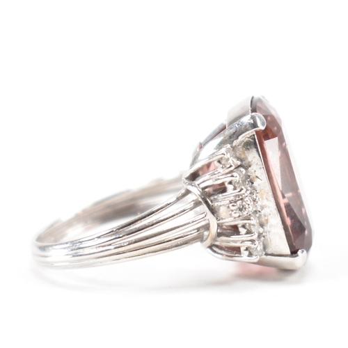 290 - A white gold tourmaline and diamond cocktail ring. The ring set with a pinkish brown tourmaline flan... 