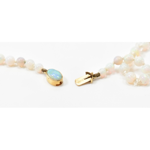 305 - A vintage opal and rock crystal necklace. The necklace being alternately threaded with round opal be... 