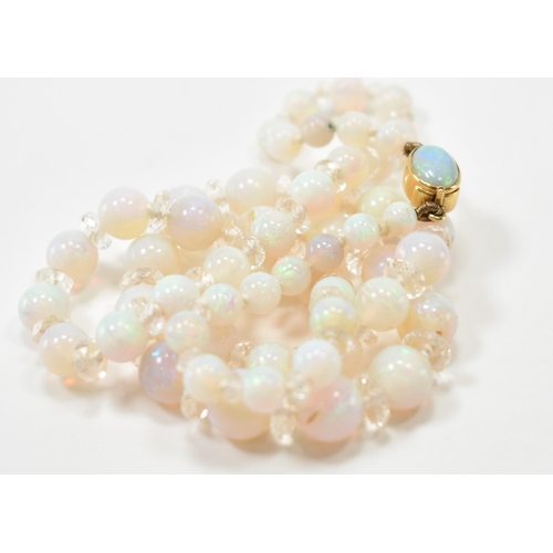 305 - A vintage opal and rock crystal necklace. The necklace being alternately threaded with round opal be... 