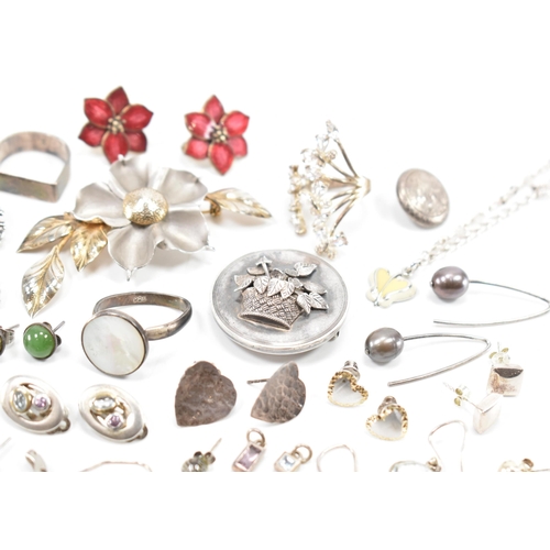 531 - A collection of silver and white metal earrings and brooches. The lot to include a Victorian mournin... 