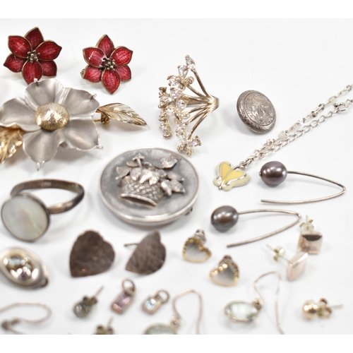 531 - A collection of silver and white metal earrings and brooches. The lot to include a Victorian mournin... 