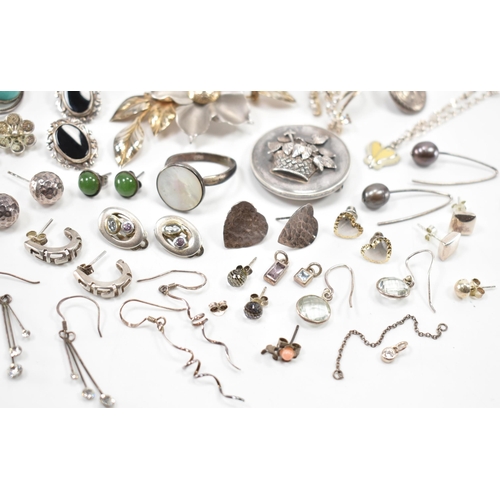 531 - A collection of silver and white metal earrings and brooches. The lot to include a Victorian mournin... 