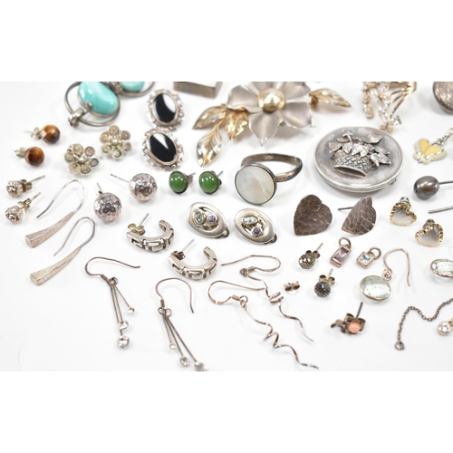 531 - A collection of silver and white metal earrings and brooches. The lot to include a Victorian mournin... 