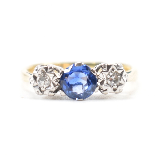 201 - An 18ct gold sapphire and diamond three stone ring. The ring being set with a round cut blue sapphir... 